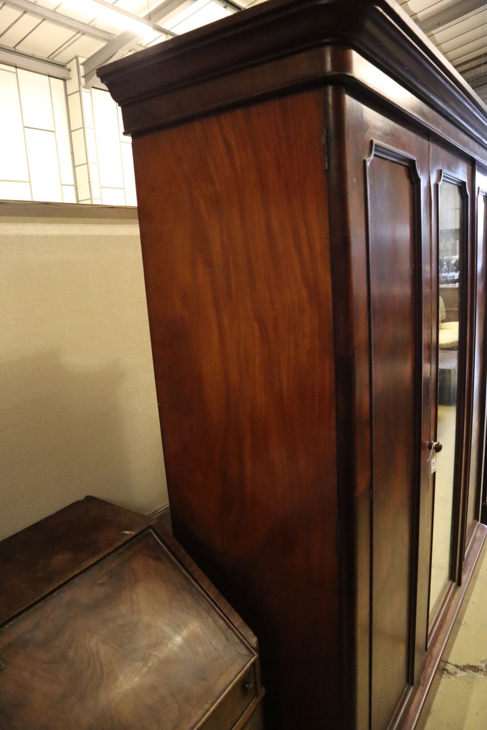 A Victorian mahogany three door wardrobe, with a central mirrored door, width 190cm depth 60cm height 208cm